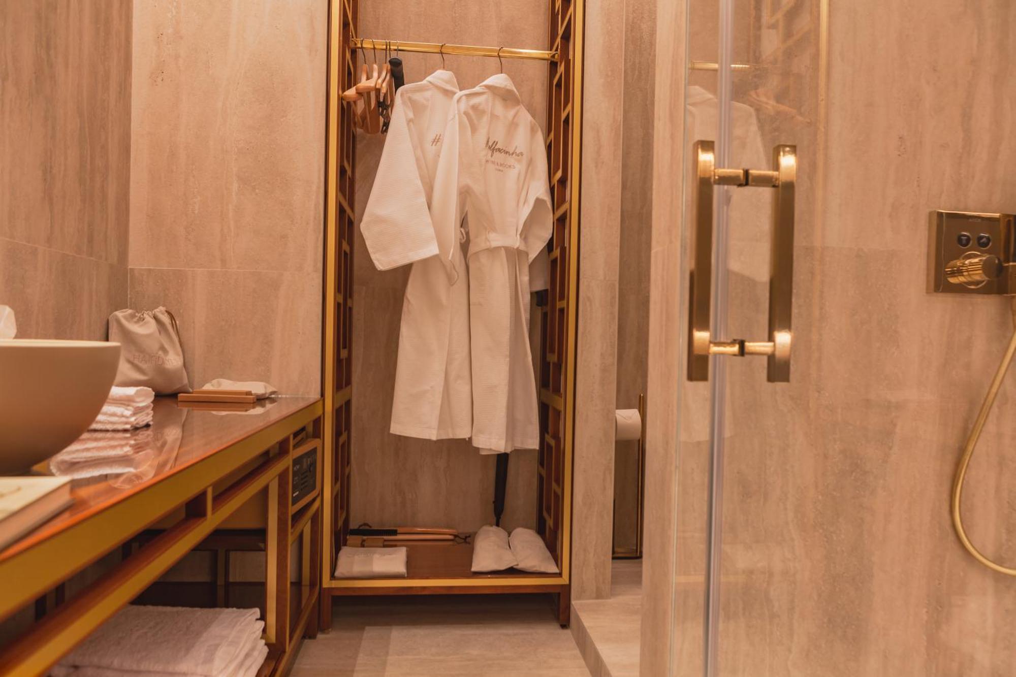 Wine & Books Lisboa Hotel Номер фото A bathrobe in a hotel bathroom
